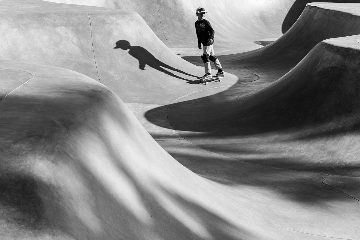 people greyscale photo of boy in the skateboard ring black-and-white