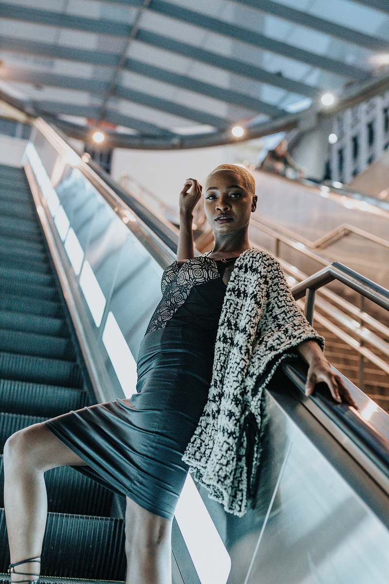 person low-angle photography of woman on escalator people