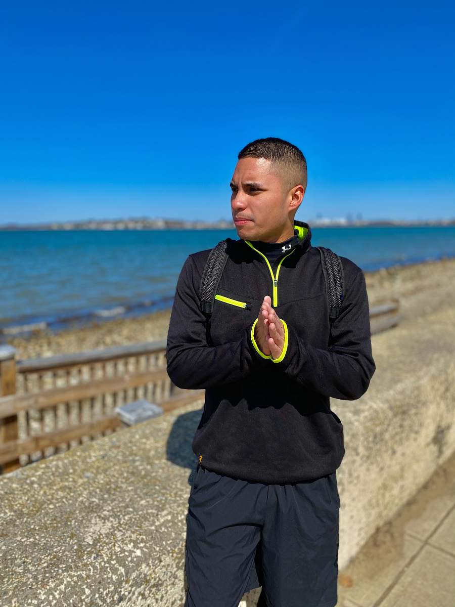 clothing man in black jacket holding green telephone apparel