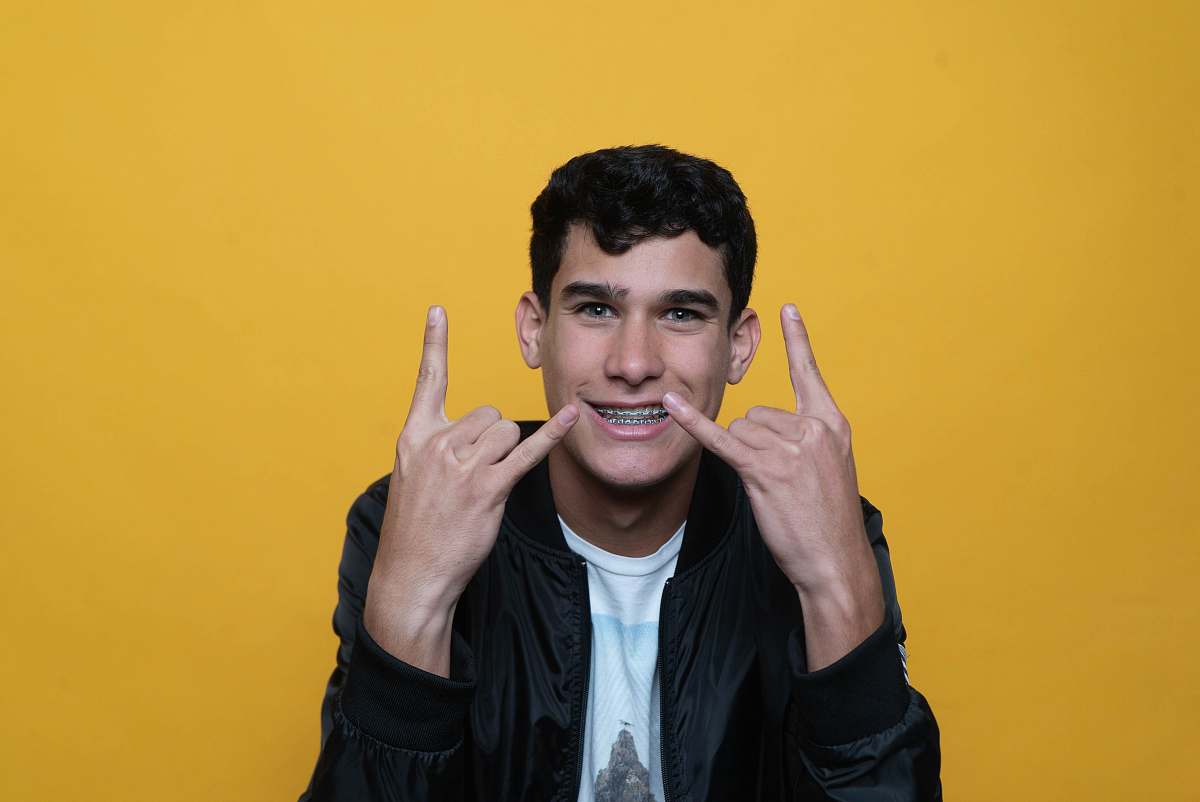 person man in black zip up jacket finger