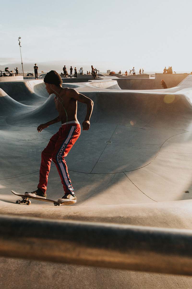person man playing skateboard during daytime people