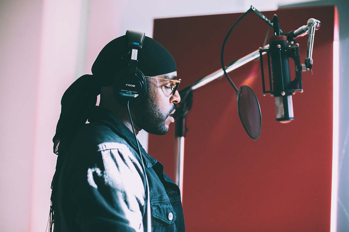people man singing infront of condenser microphone person