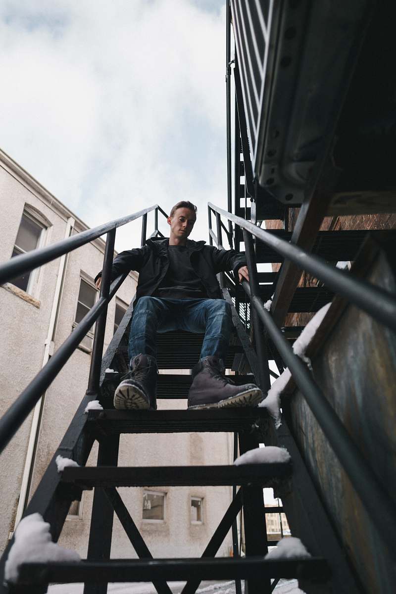 person man sitting on stairs people
