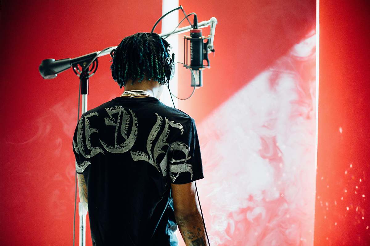 person man standing in front of condenser microphone people