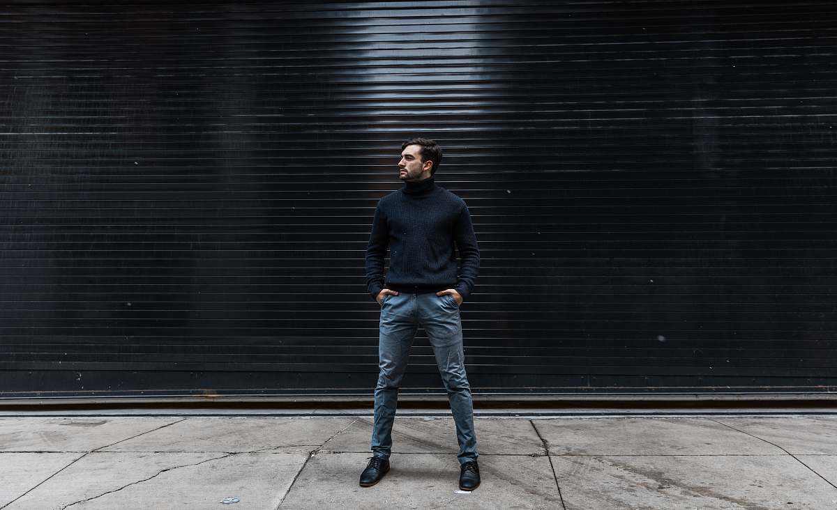 people man standing near black shutter door person