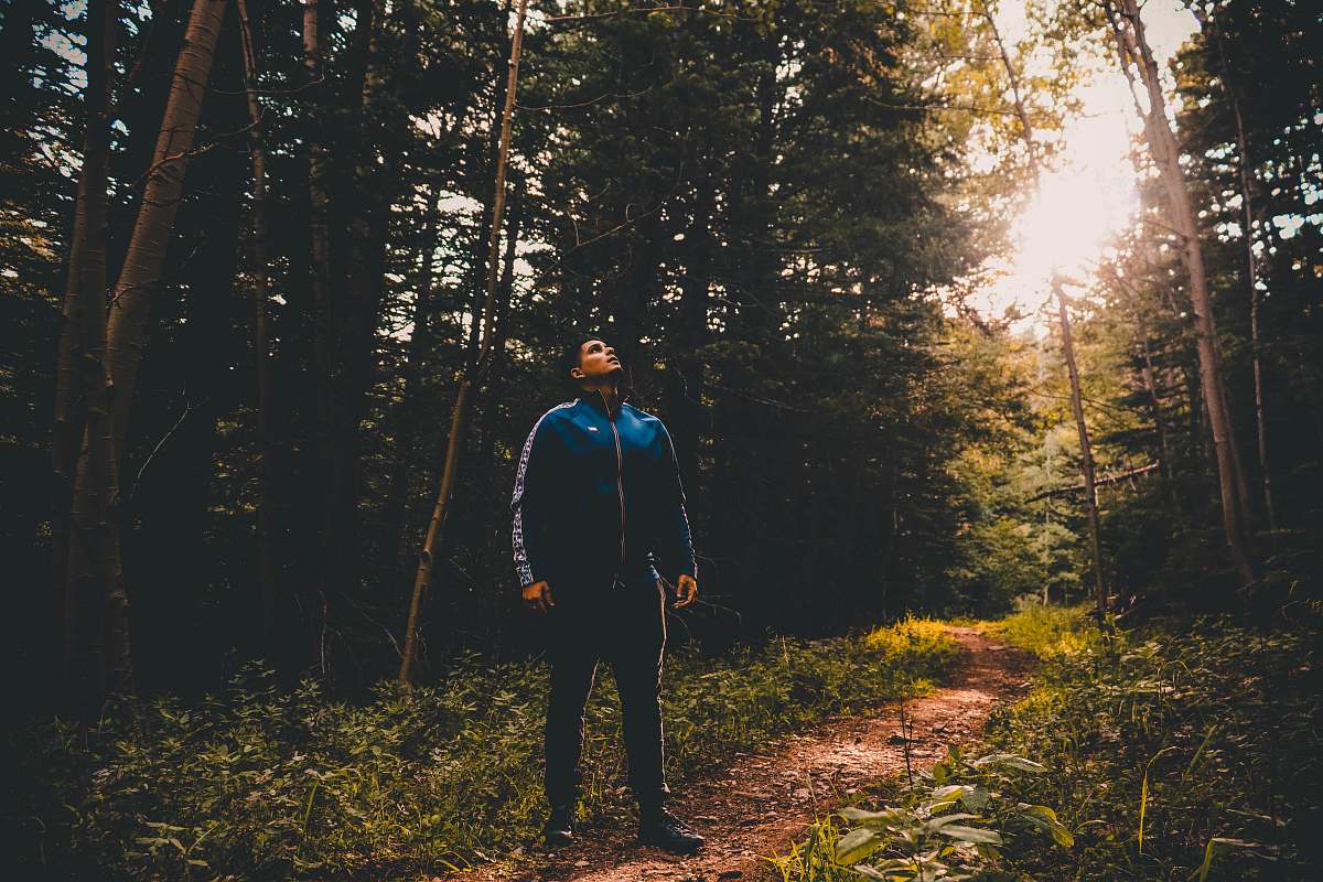 people man standing near green trees during daytime person
