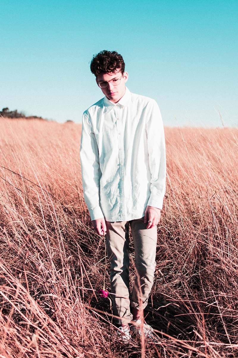 person man wearing blue button-up long-sleeved dress shirt on the brown grass people