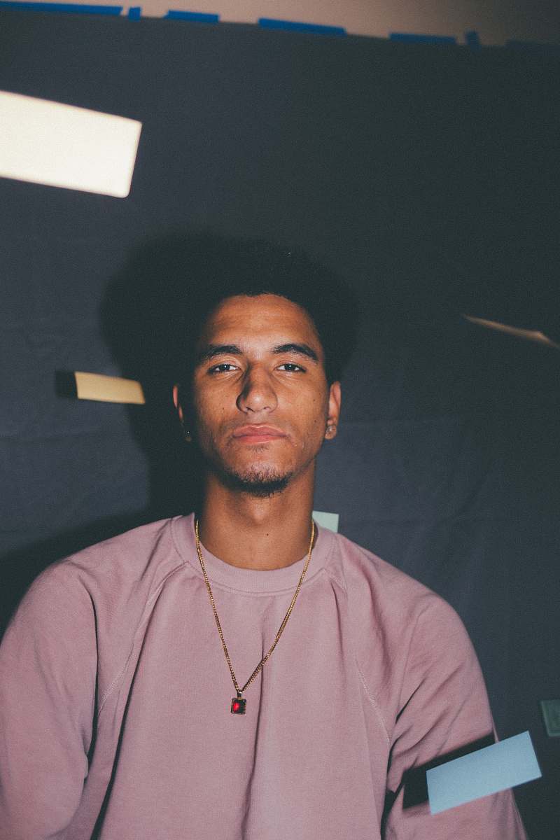 person man wearing pink crew-neck t-shirt pendant