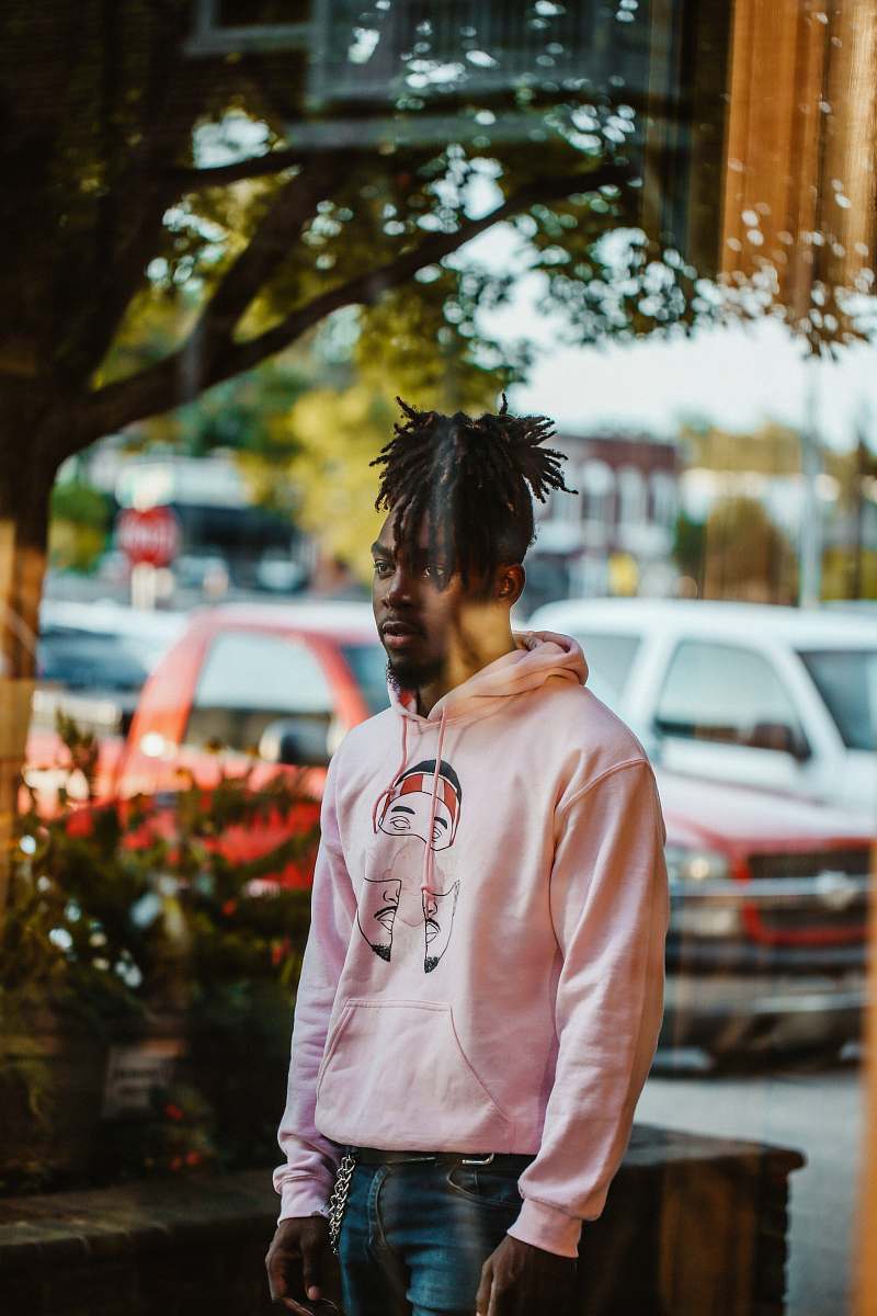 people man wearing pink pullover hoodie person