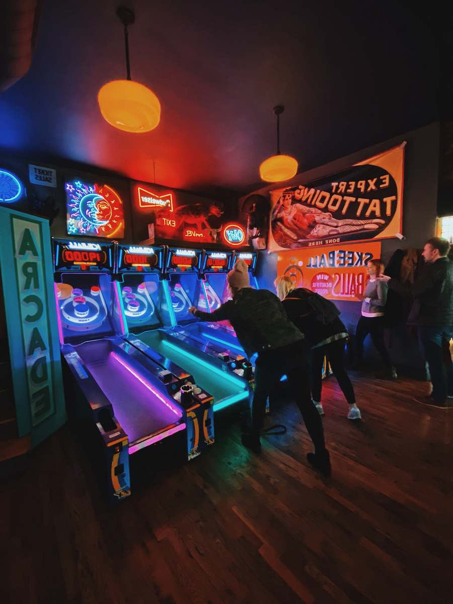 person people playing arcade game inside room st. louis