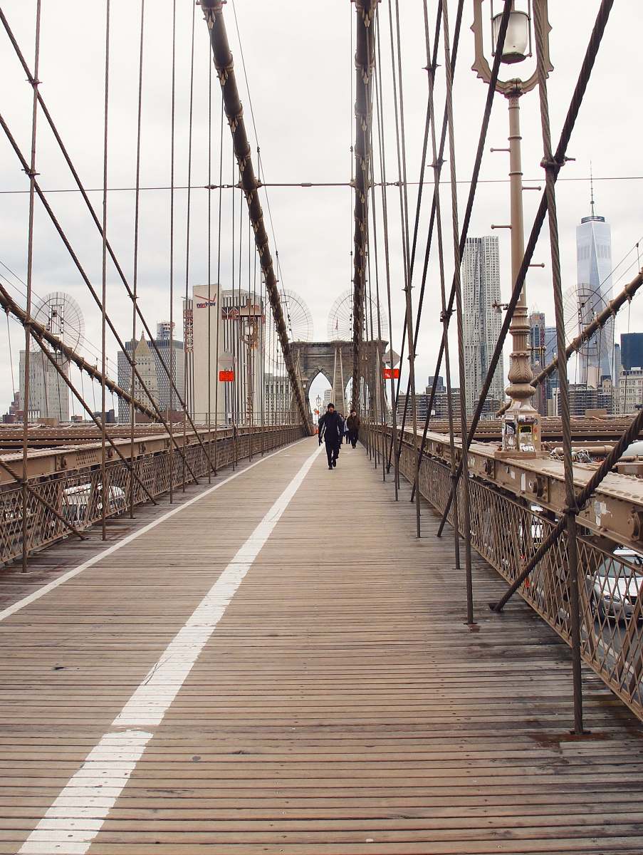 person people walking on bridge during dayime bridge