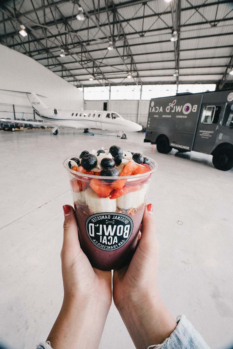 person person holding Bowl'D acai cup people