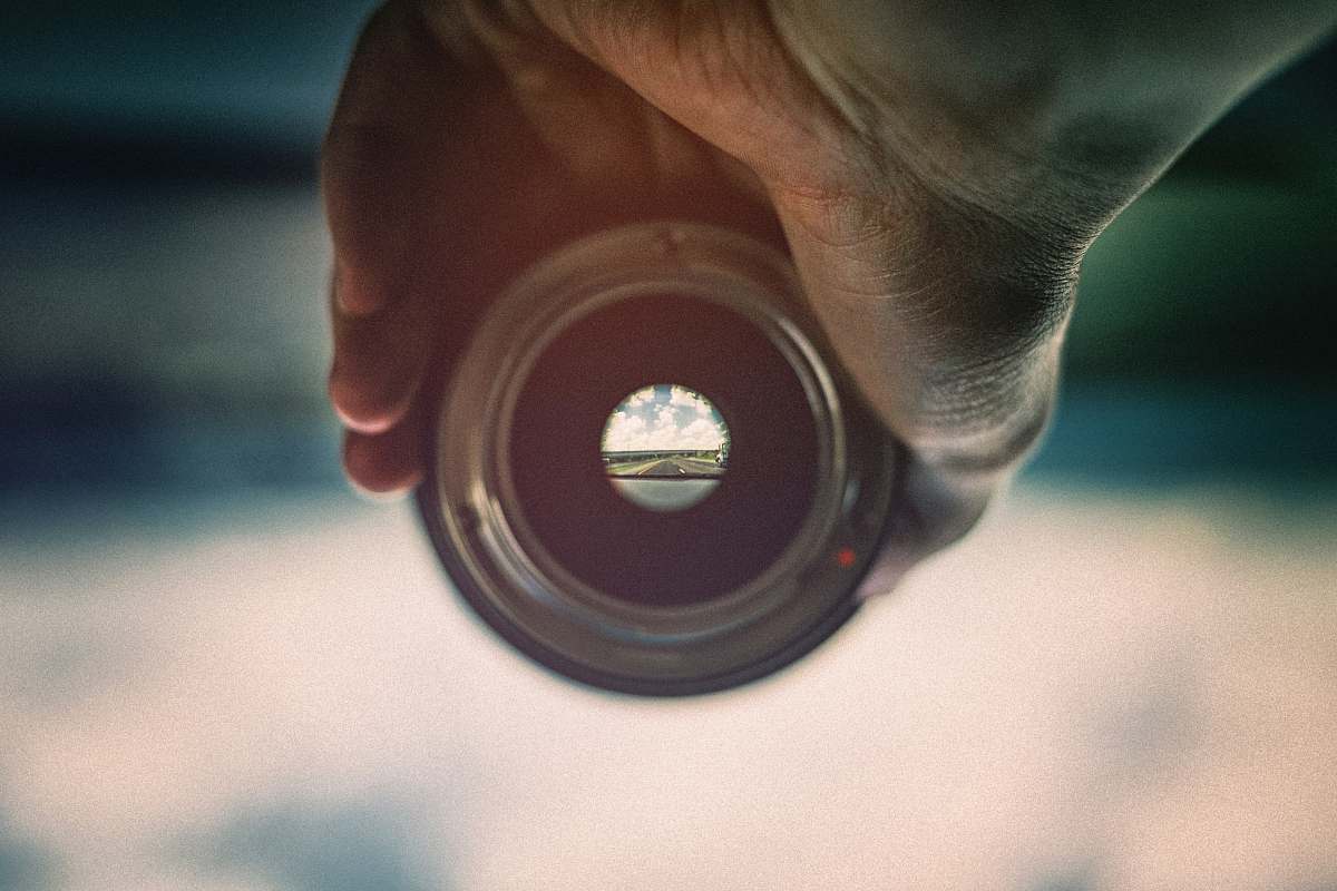 person person holding camera lens viewing mountains people