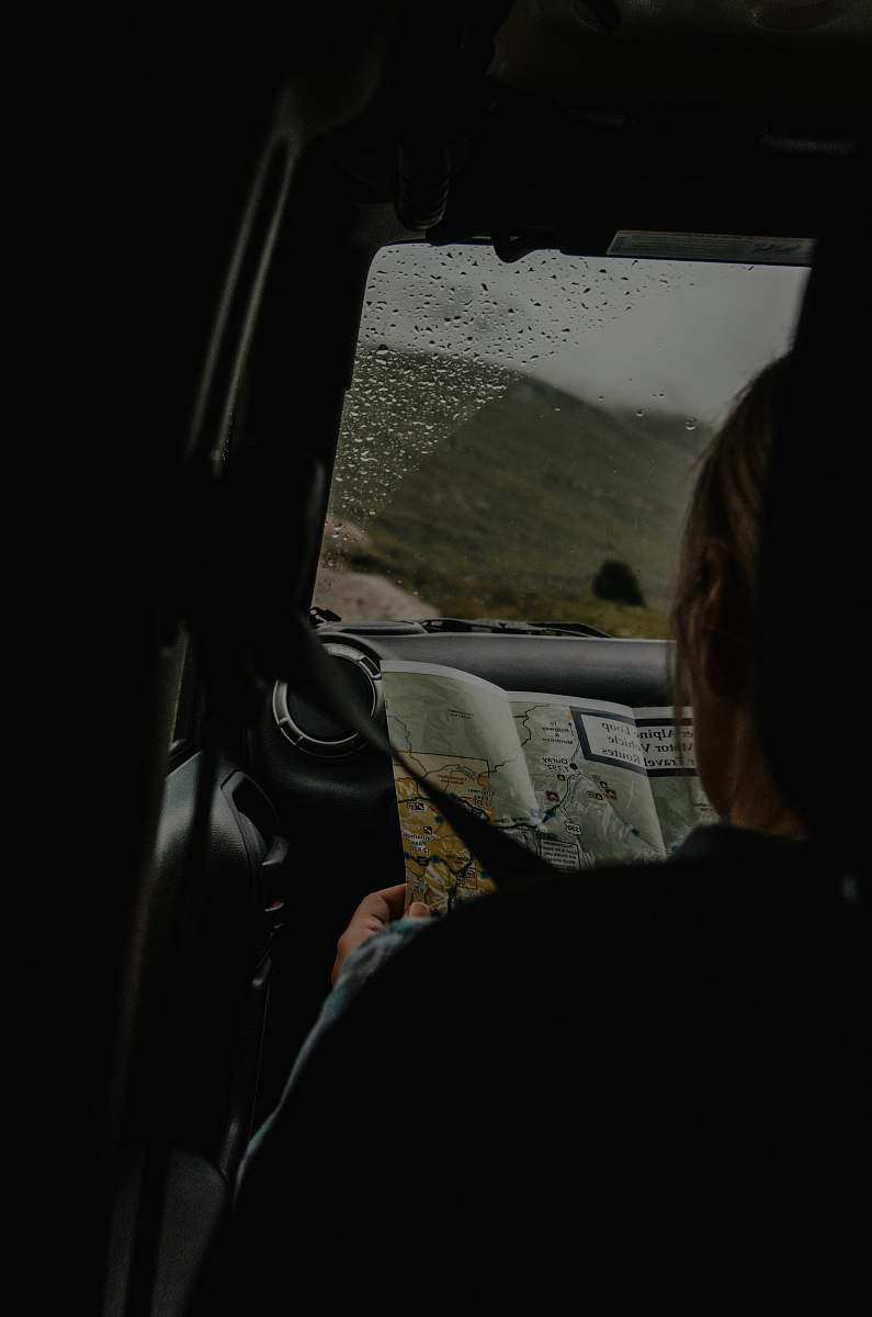 person person sitting on front passenger seat holding map people