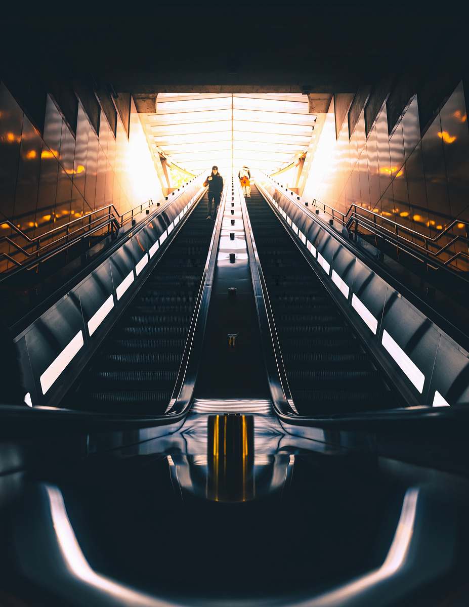 banister person standing on escalator handrail