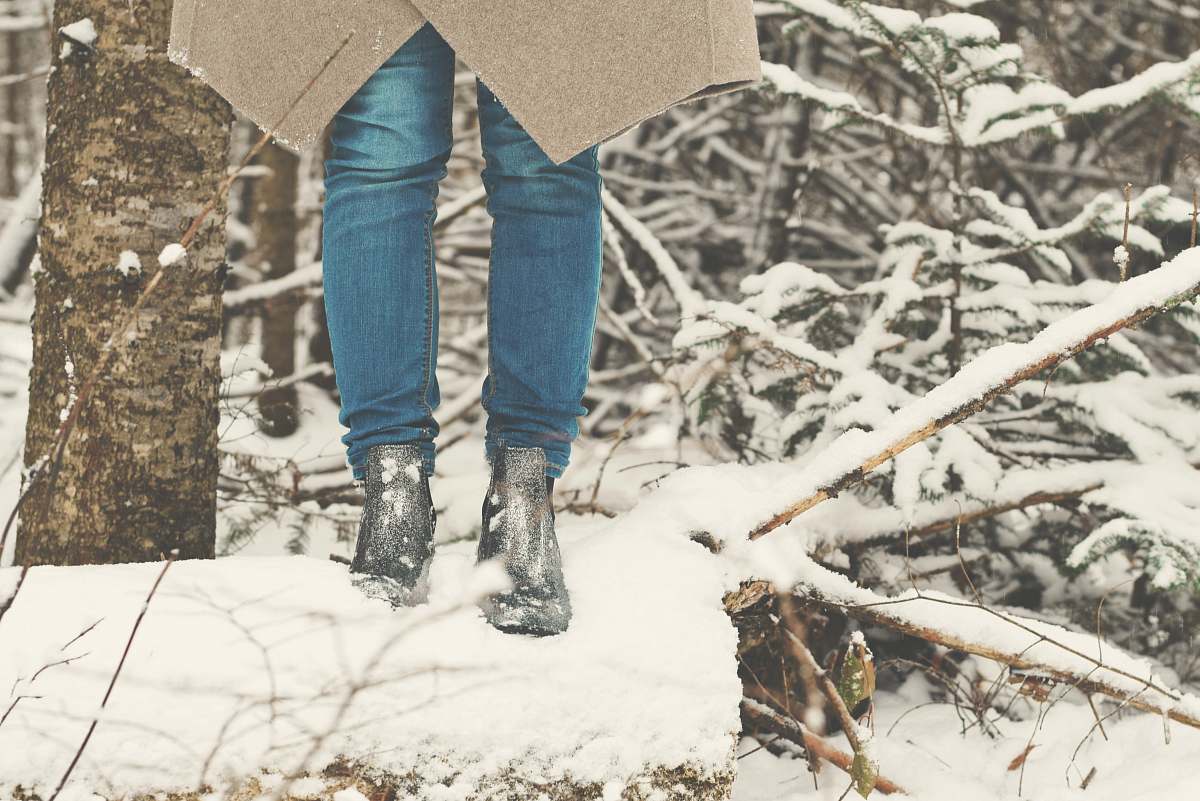 person person standing on tree log snow