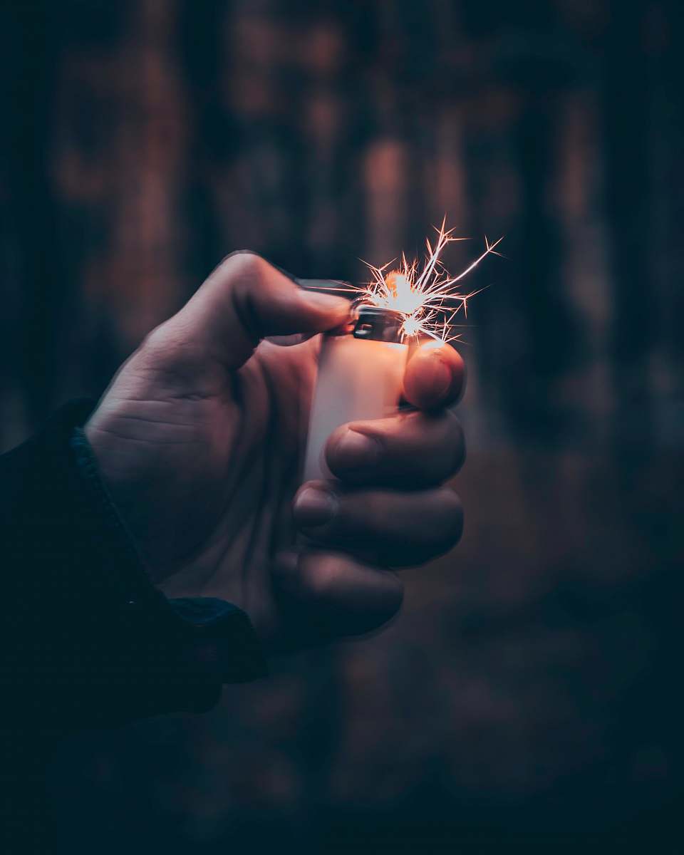 person person using white disposable lighter people