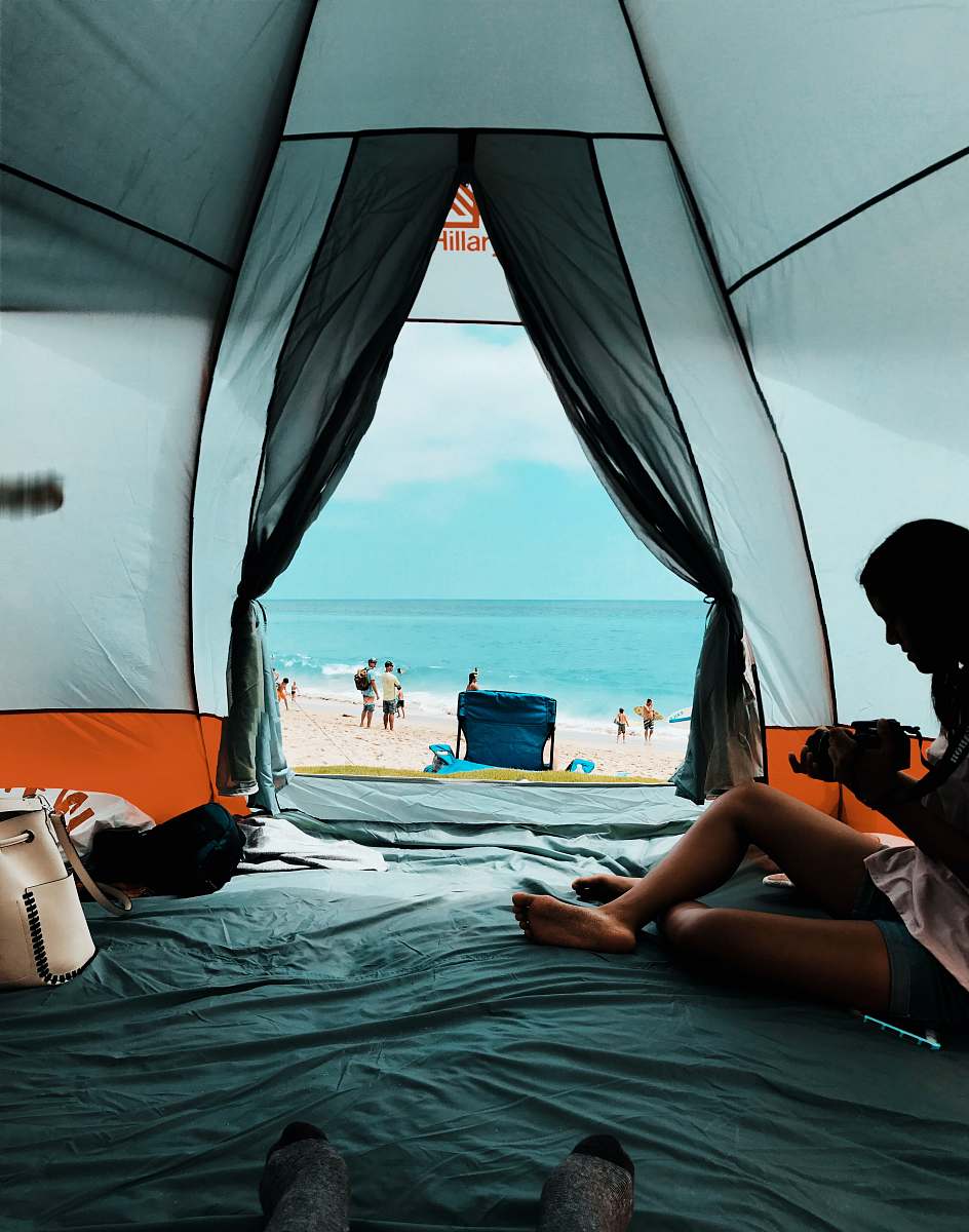 person photo of person sitting inside the tent people