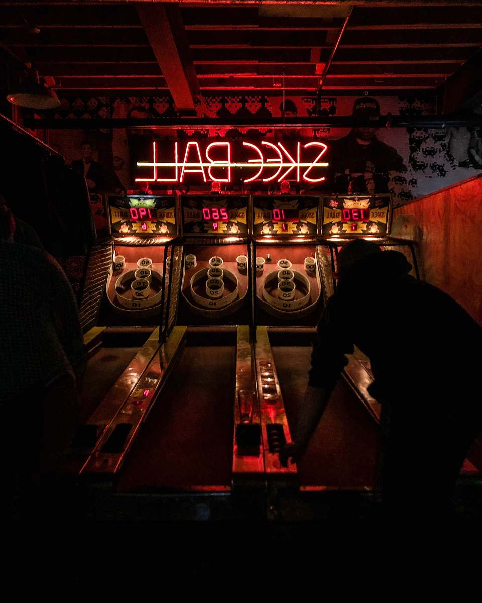 person Skeeball arcade machine arcade game machine