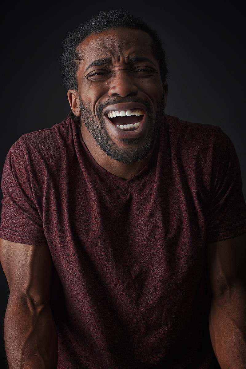 person smiling man wearing brown t-shirt face
