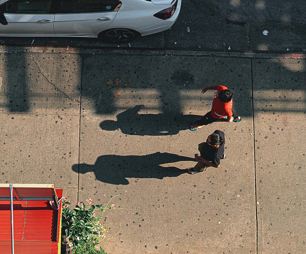 person two people walking near vehicle park automobile
