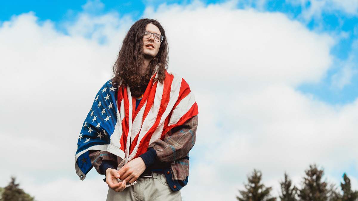 person U.S. America flag on man wearing brown jacket people
