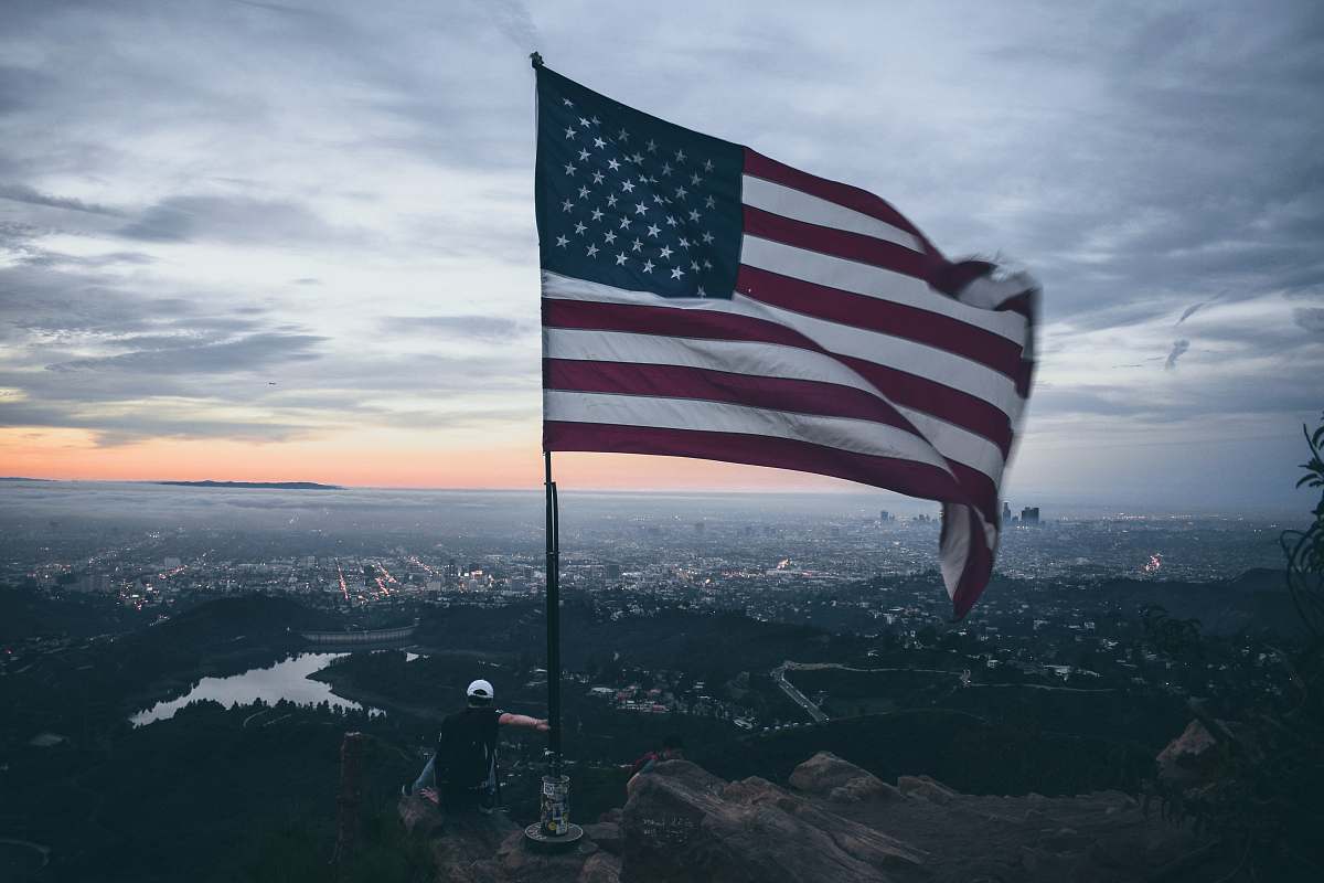 person waving USA flag symbol