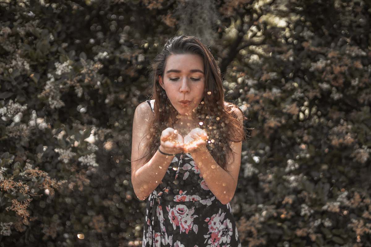 person woman blowing her hands people
