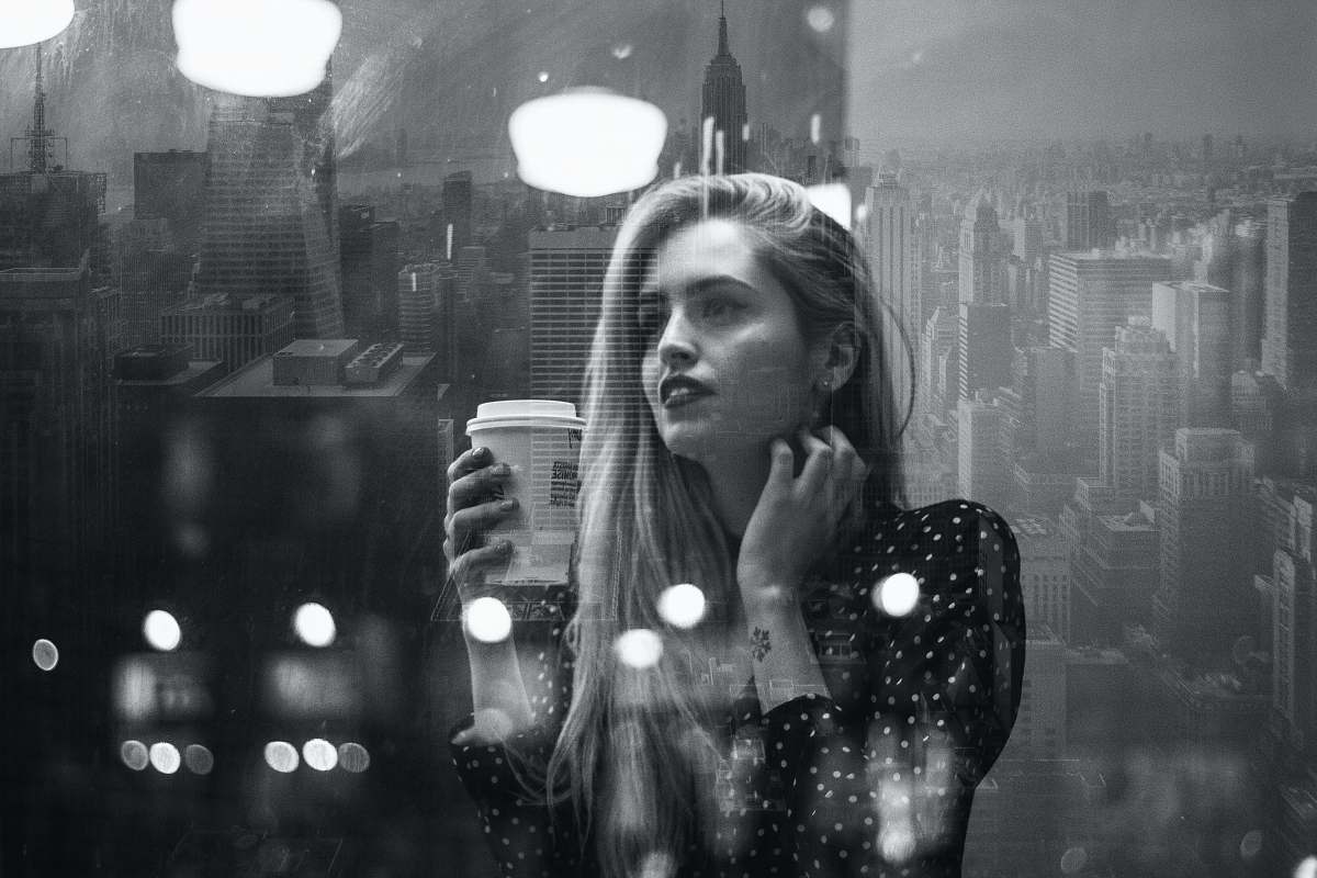 people woman holding coffee up black-and-white