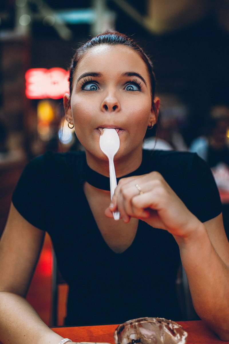 person woman holding spoon on tongue people