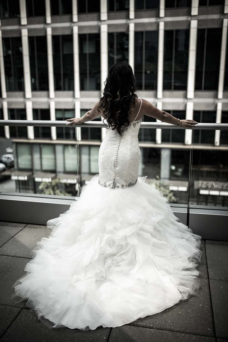 wedding woman in white wedding dress standing in front balustrades bride