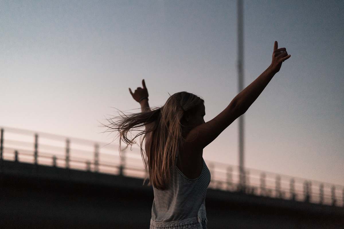 person woman raising his hands during daytime people