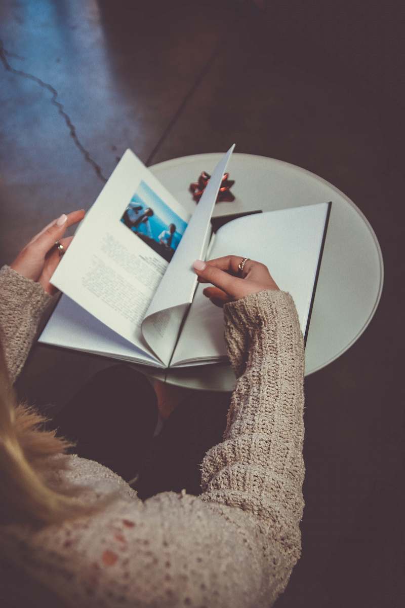 person woman reading a book people