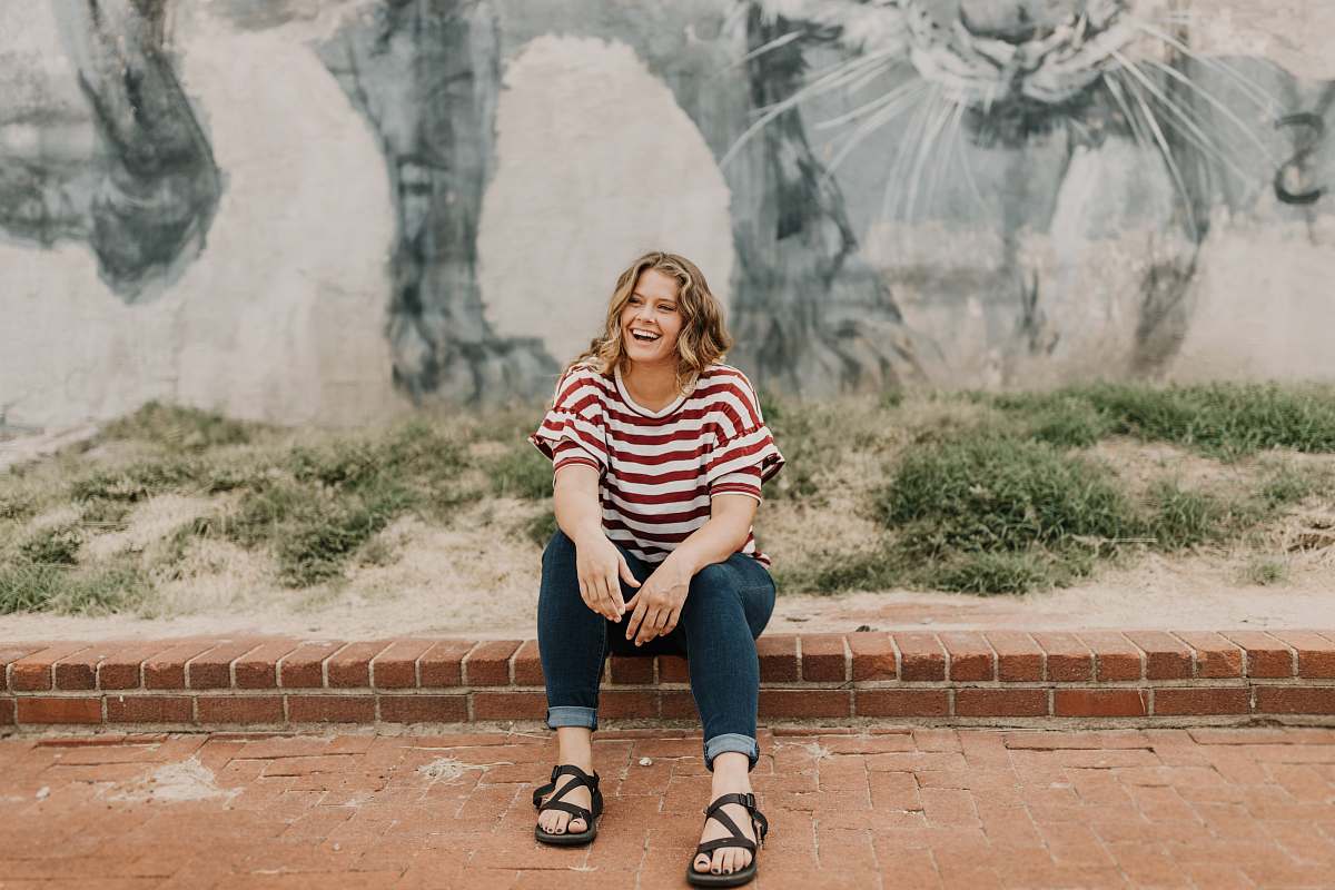 person woman sitting on brick tile people