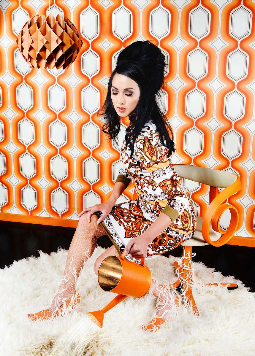 female woman sitting on chair while holding watering can girl