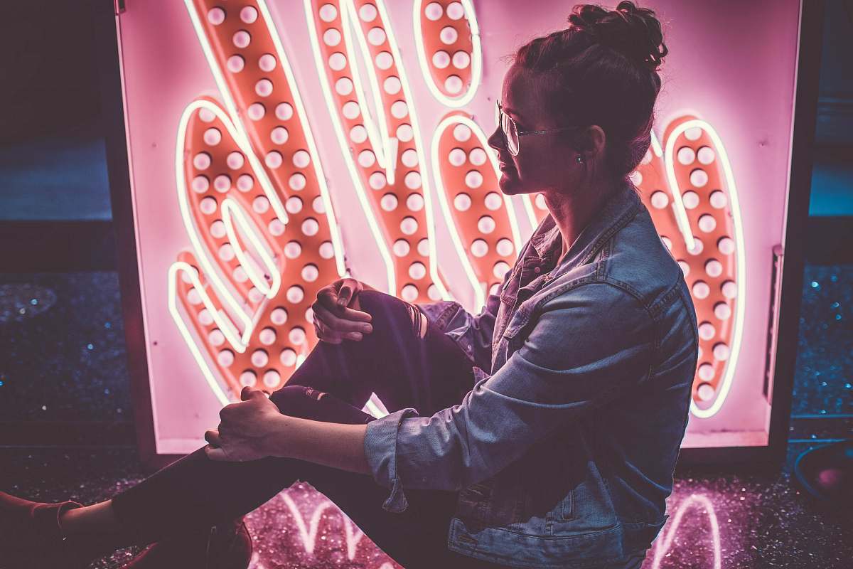 people woman sitting on floor while holding her knee person
