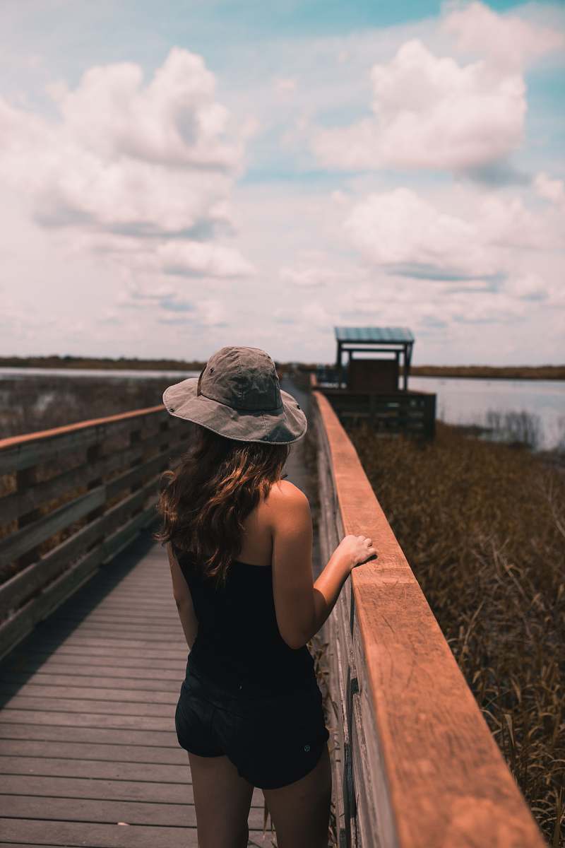 person woman standing on boardwalk people