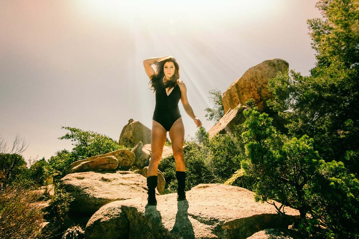 person woman standing on rock formation people