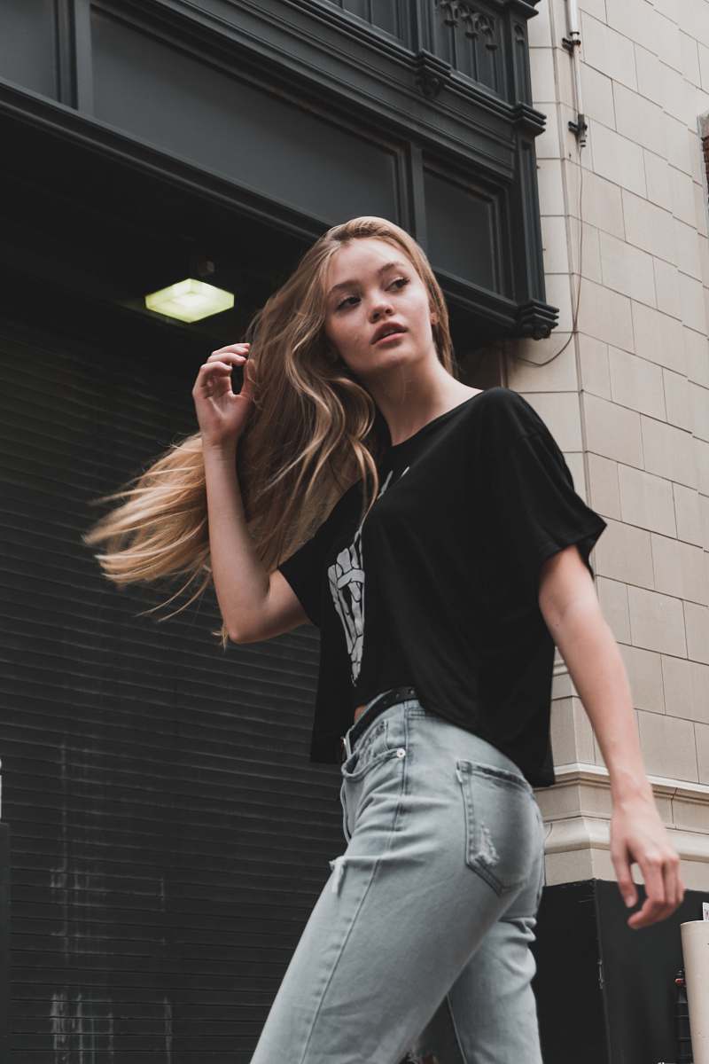 apparel woman walking near building clothing