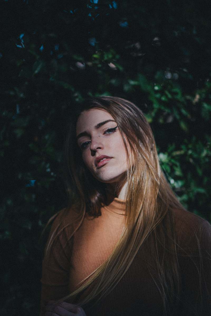 person woman wearing orange turtle-neck shirt close-up photo people
