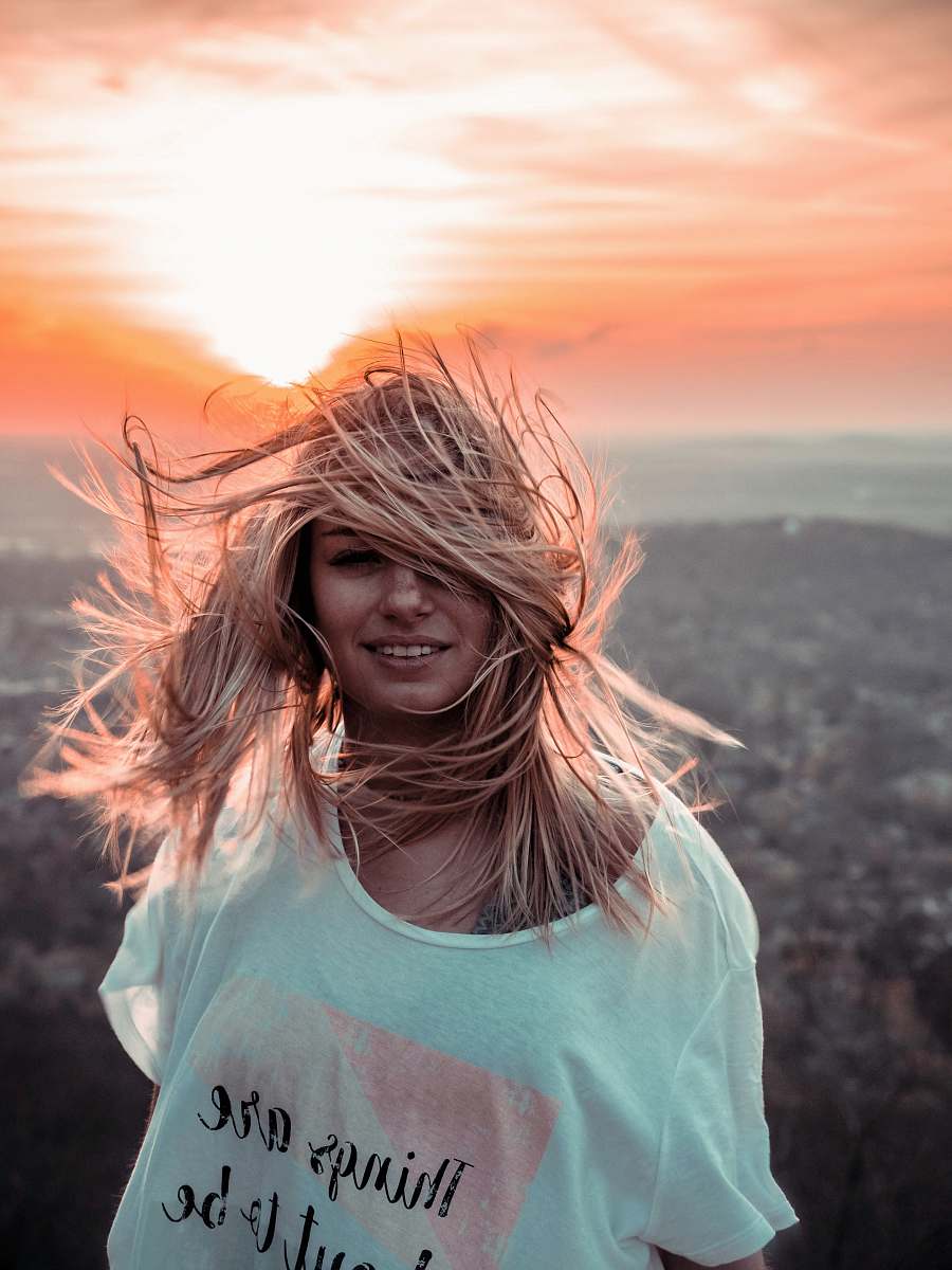 This stunning image captures a confident woman dressed in a crisp white shirt, standing triumphantly atop a majestic mountain. The breathtaking view showcases the vast expanse of nature, symbolizing freedom and adventure. Perfect for travel blogs, fashion magazines, or inspirational content, this photograph embodies the spirit of exploration and personal growth. Whether used for commercial projects or personal inspiration, it serves as a powerful reminder of the beauty that lies in pursuing one's dreams.