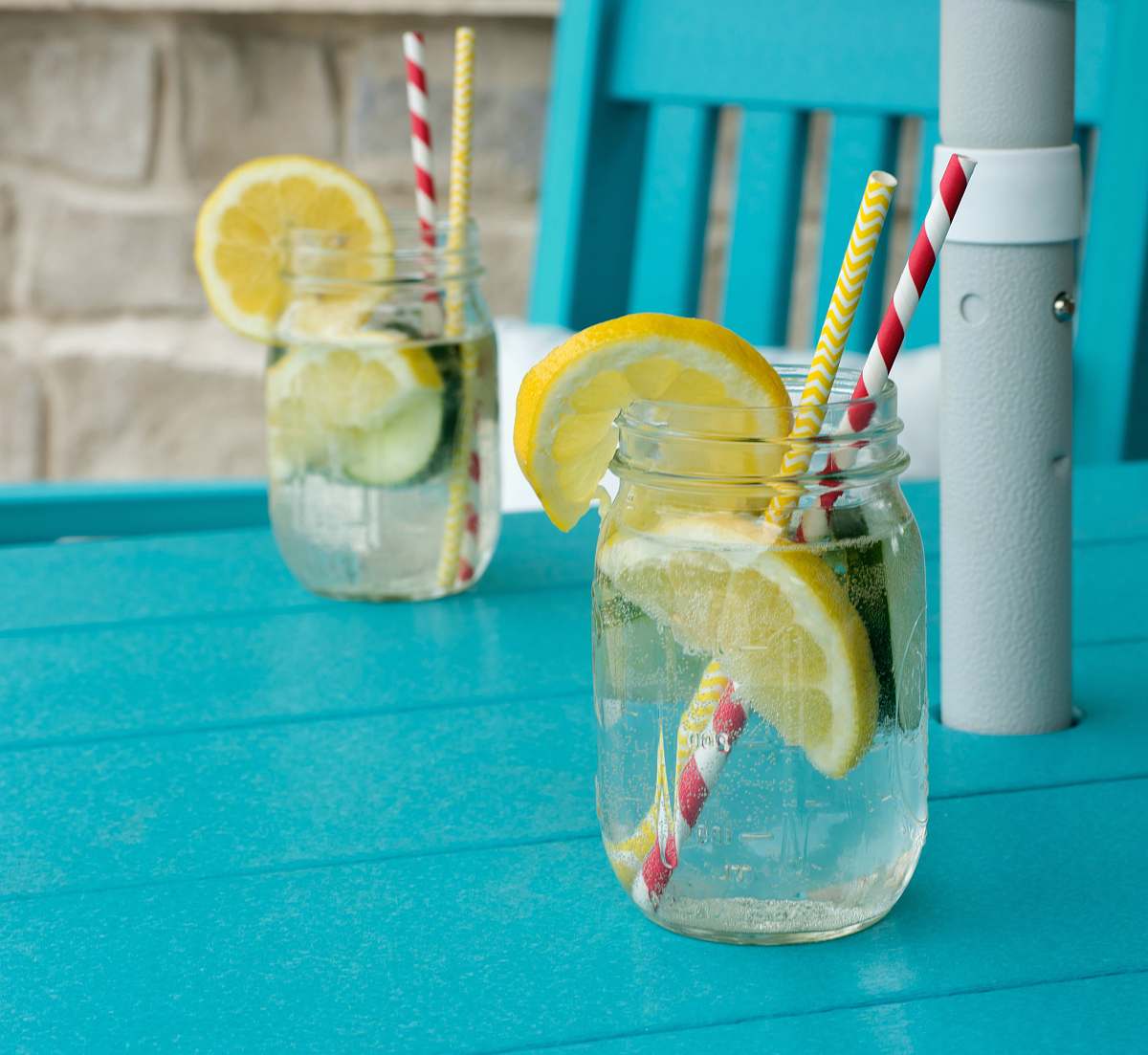 drink sliced lemon in clear glass jar alcohol