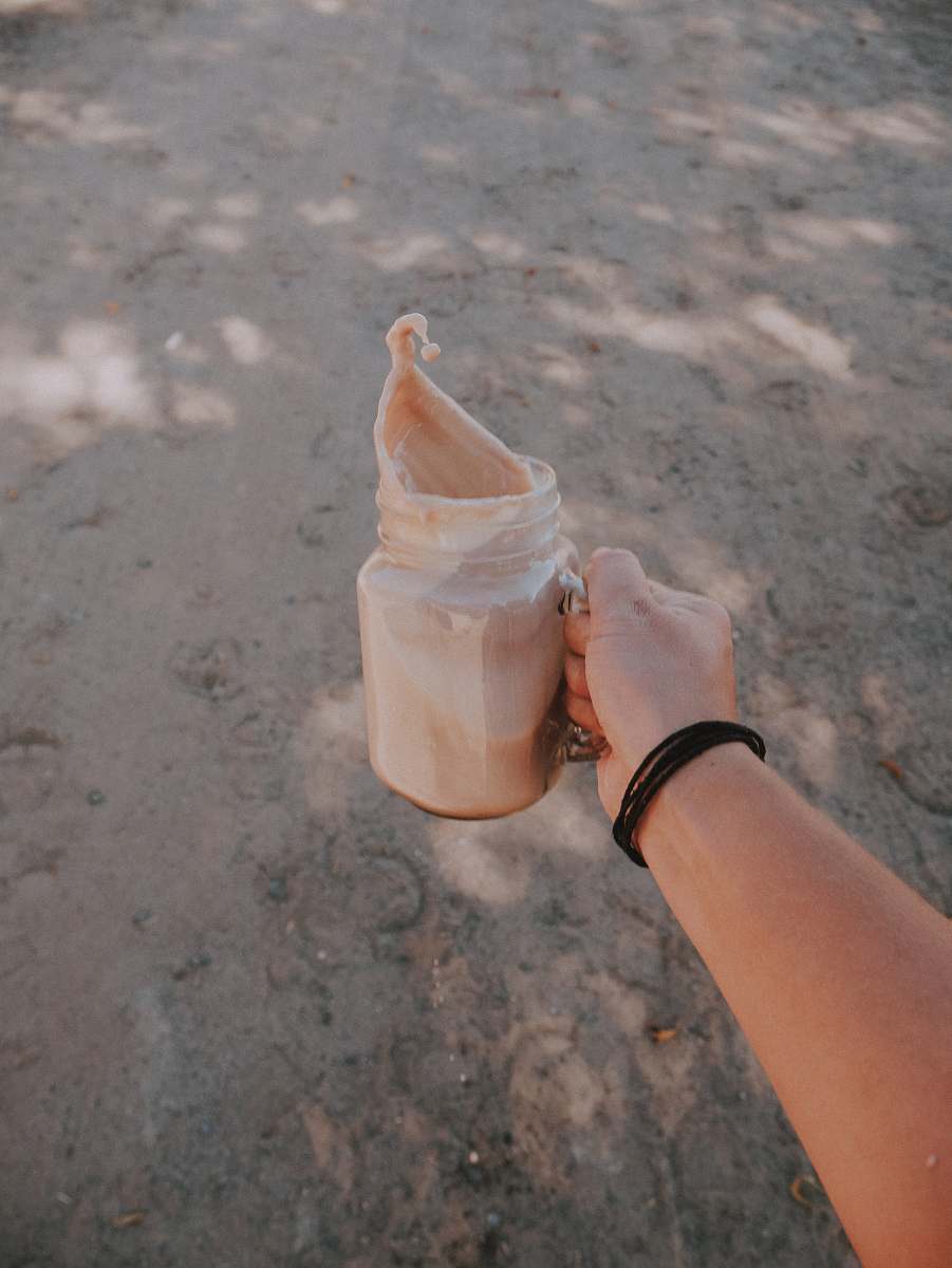 pitcher person holding mason jar water jug