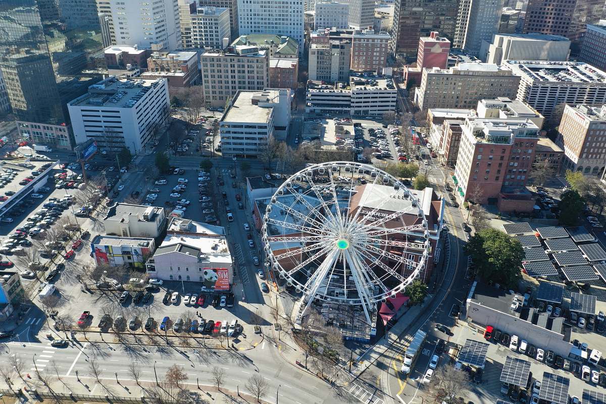 nature gray ferris wheel surround by buildings outdoors