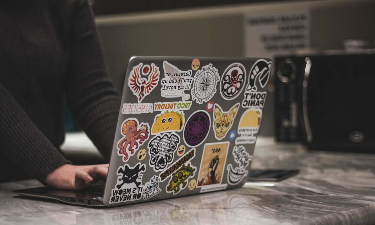 person person surfing black laptop near microwave oven neonbrand digital marketing
