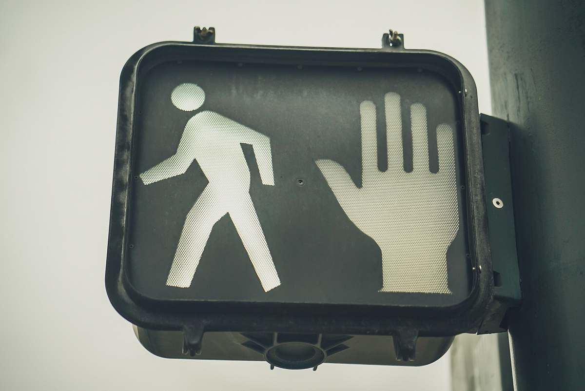 grey black go and stop pedestrian signage broadway