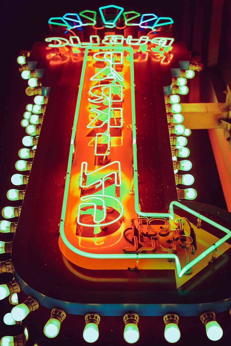 neon close-up photo ofgreen and orange arrow neon light signage fort lauderdale
