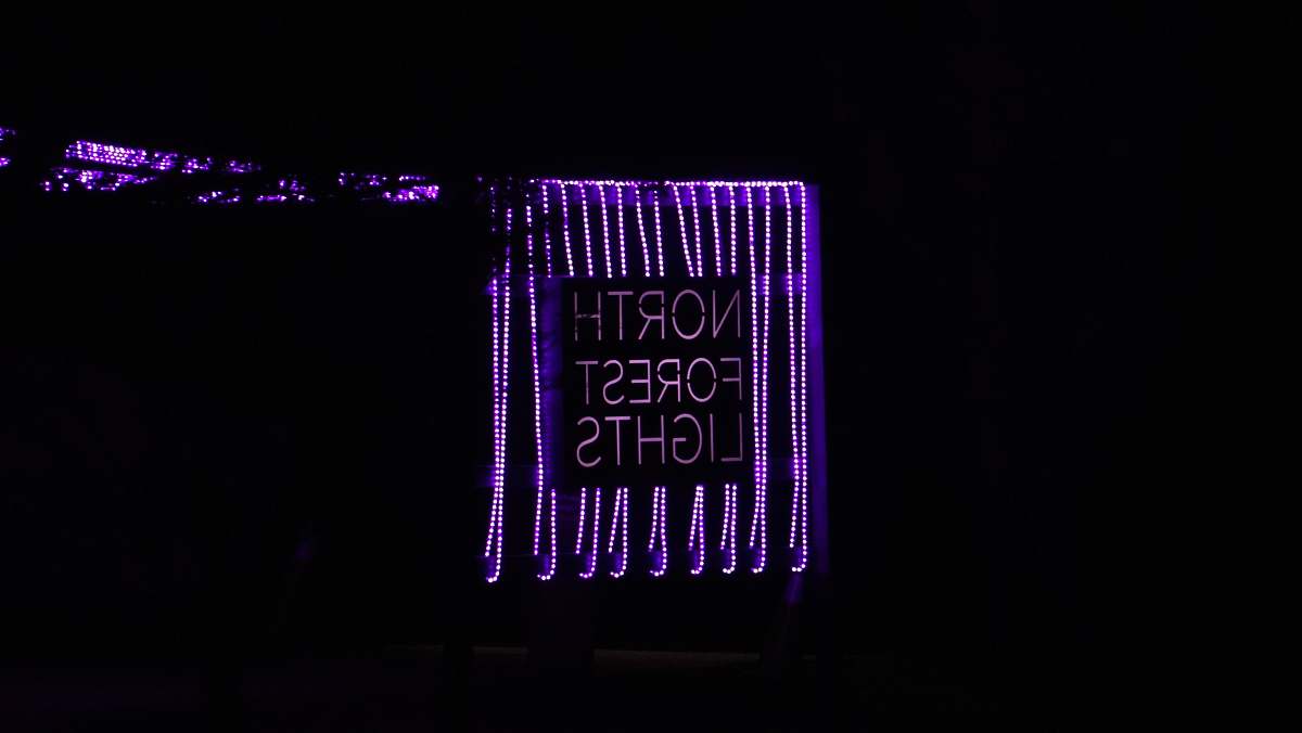 neon purple and black love me text bentonville
