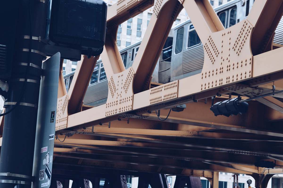 suitcase train passing on hanging railway during daytime chicago