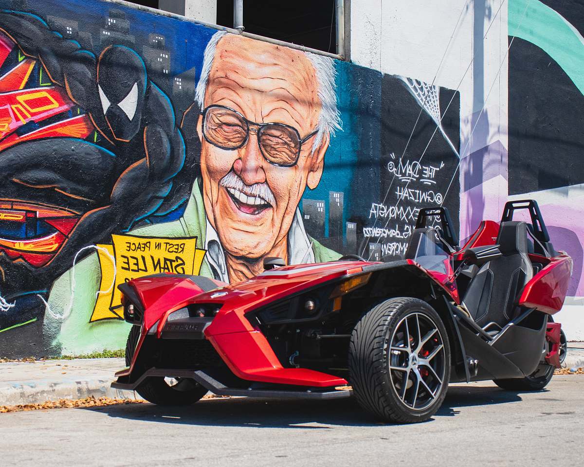 wheel red and black sports car beside wall spoke